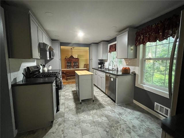 5 White Birch Cir, Chili, NY 14624 - kitchen featuring stainless steel appliances, under cabinet range hood, a kitchen island, and wood counters