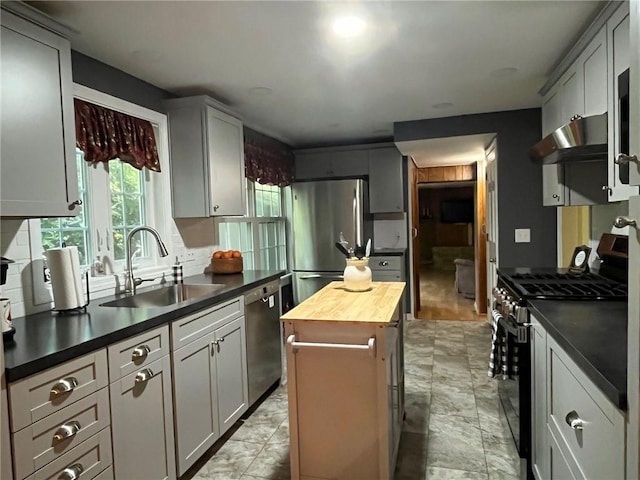 5 White Birch Cir, Chili, NY 14624 - kitchen with appliances with stainless steel finishes, butcher block counters, range hood, decorative backsplash, and a kitchen island