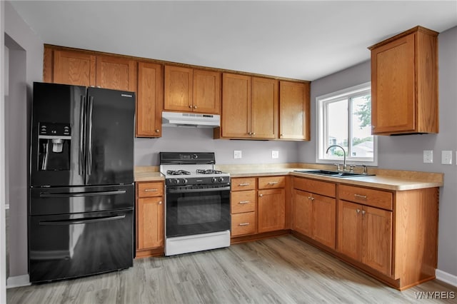 355 Fawn, West Seneca, NY 14224 - kitchen with black fridge with ice dispenser, gas stove, under cabinet range hood, light wood-style flooring, and light countertops