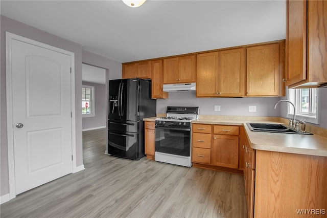 355 Fawn, West Seneca, NY 14224 - kitchen featuring white range with gas cooktop, black fridge with ice dispenser, under cabinet range hood, light wood finished floors, and light countertops