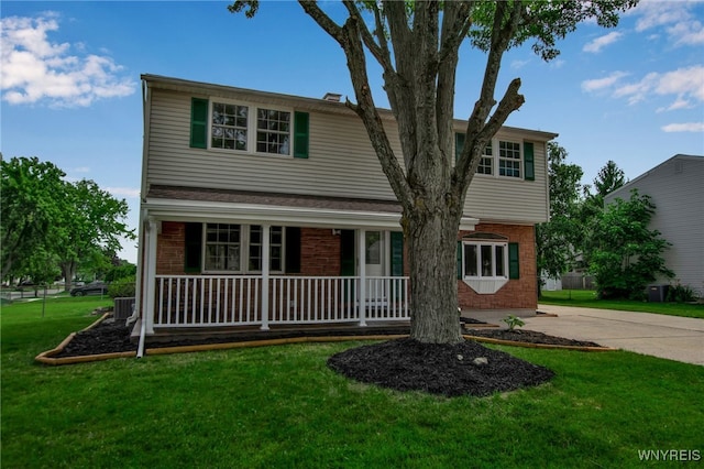 355 Fawn, West Seneca, NY 14224 - traditional-style home with a porch, brick siding, a front yard, and concrete driveway