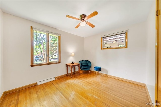 36 Lennox Ave, Amherst, NY 14226 - unfurnished room with a baseboard heating unit, light wood-style flooring, and a ceiling fan