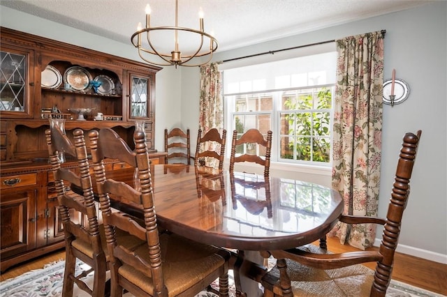 158 Pine Valley Dr, Greece, NY 14626 - dining area featuring a chandelier, light wood-type flooring, and a textured ceiling