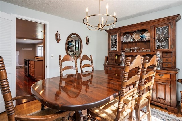158 Pine Valley Dr, Greece, NY 14626 - dining space featuring wood finished floors, a chandelier, and a textured ceiling