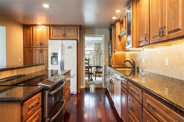 158 Pine Valley Dr, Greece, NY 14626 - kitchen with double oven range, brown cabinets, dark stone countertops, and recessed lighting