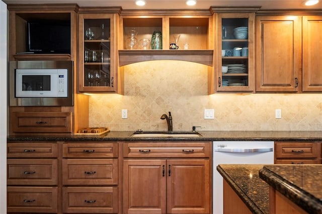 158 Pine Valley Dr, Greece, NY 14626 - kitchen featuring white appliances, dark stone counters, decorative backsplash, brown cabinetry, and recessed lighting
