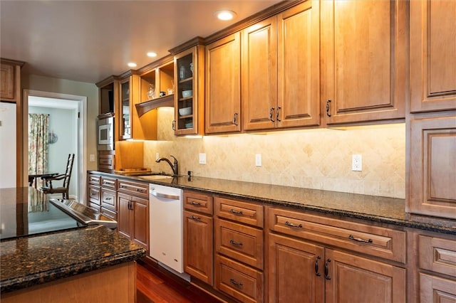 158 Pine Valley Dr, Greece, NY 14626 - kitchen with dishwasher, recessed lighting, stainless steel microwave, glass insert cabinets, and dark stone countertops