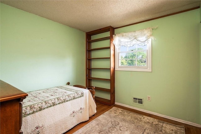 158 Pine Valley Dr, Greece, NY 14626 - bedroom featuring a textured ceiling and wood finished floors