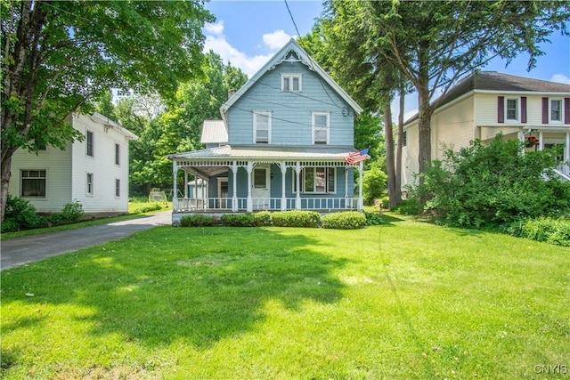 14309 Maple St, Diana, NY 13648 - victorian house with a porch, a front yard, and a metal roof
