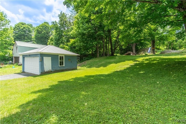 14309 Maple St, Diana, NY 13648 - view of grassy yard with an outbuilding, a detached garage, and asphalt driveway