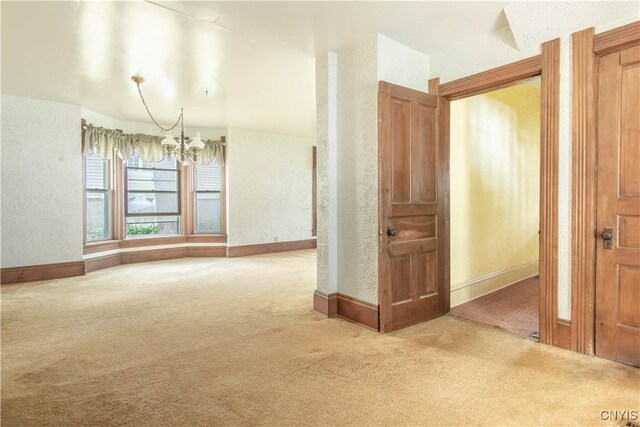 14309 Maple St, Diana, NY 13648 - spare room with carpet, a chandelier, and a textured wall