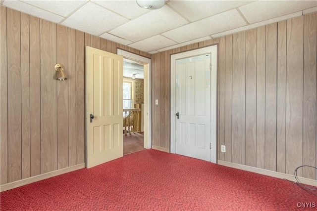 14309 Maple St, Diana, NY 13648 - carpeted spare room featuring wood walls and a paneled ceiling