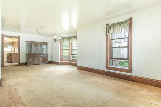14309 Maple St, Diana, NY 13648 - carpeted spare room featuring a chandelier and baseboards