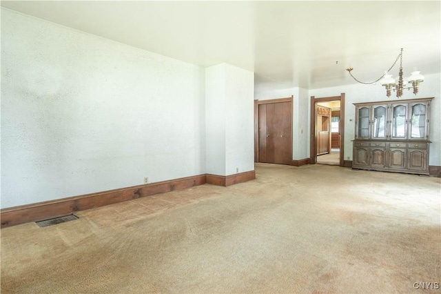14309 Maple St, Diana, NY 13648 - carpeted empty room featuring baseboards and a chandelier