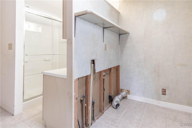 14309 Maple St, Diana, NY 13648 - laundry area featuring light tile patterned floors and baseboards