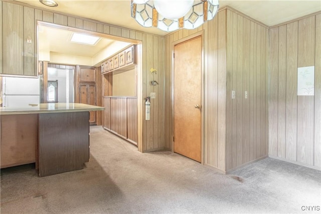 14309 Maple St, Diana, NY 13648 - kitchen featuring light colored carpet and wood walls
