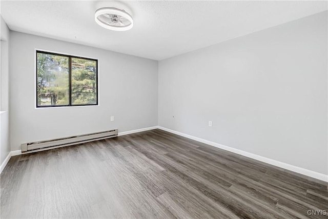 279 Watertree Dr, Dewitt, NY 13057 - empty room with a baseboard heating unit and dark wood-type flooring