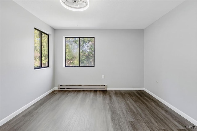 279 Watertree Dr, Dewitt, NY 13057 - spare room featuring wood finished floors and a baseboard radiator