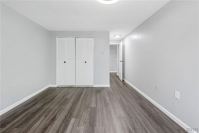 279 Watertree Dr, Dewitt, NY 13057 - unfurnished bedroom with dark wood-style flooring and a closet