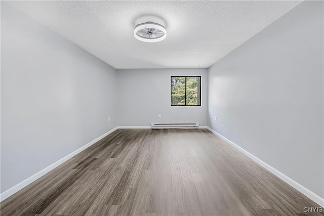 279 Watertree Dr, Dewitt, NY 13057 - empty room featuring baseboard heating, dark wood-style flooring, and a textured ceiling