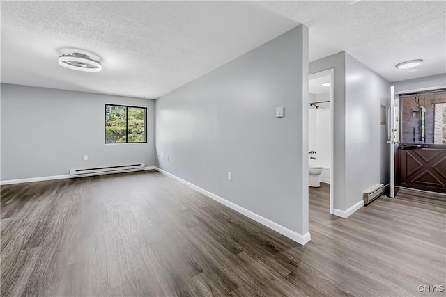 279 Watertree Dr, Dewitt, NY 13057 - spare room with a baseboard heating unit, a textured ceiling, wood finished floors, and baseboard heating