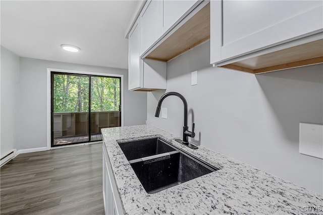 279 Watertree Dr, Dewitt, NY 13057 - kitchen with white cabinets, light stone countertops, and wood finished floors
