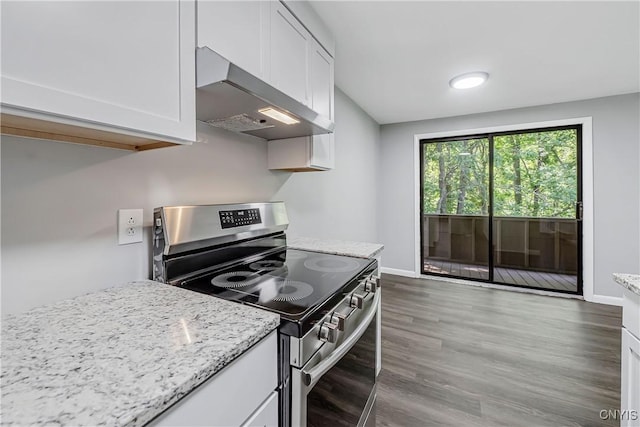 279 Watertree Dr, Dewitt, NY 13057 - kitchen featuring stainless steel range with electric cooktop, wall chimney range hood, white cabinetry, wood finished floors, and light stone counters