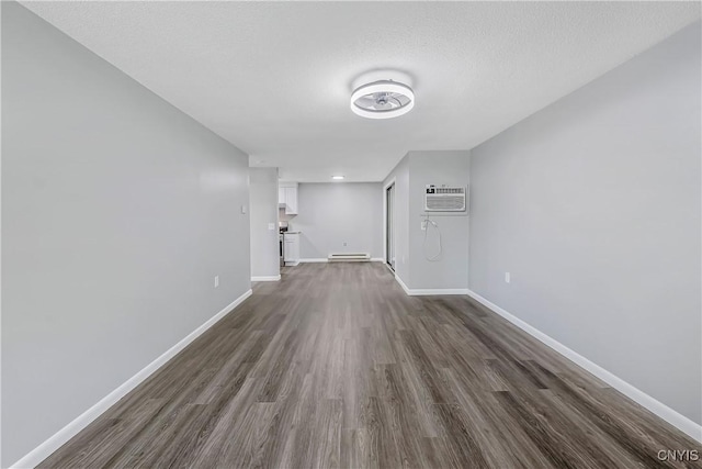 279 Watertree Dr, Dewitt, NY 13057 - unfurnished living room with dark wood-style floors, a baseboard heating unit, a wall mounted AC, and a textured ceiling