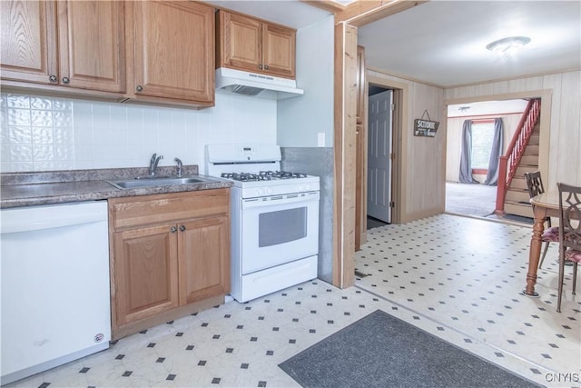 24679 Hinds Rd, Pamelia, NY 13601 - kitchen with white appliances, under cabinet range hood, light floors, and dark countertops