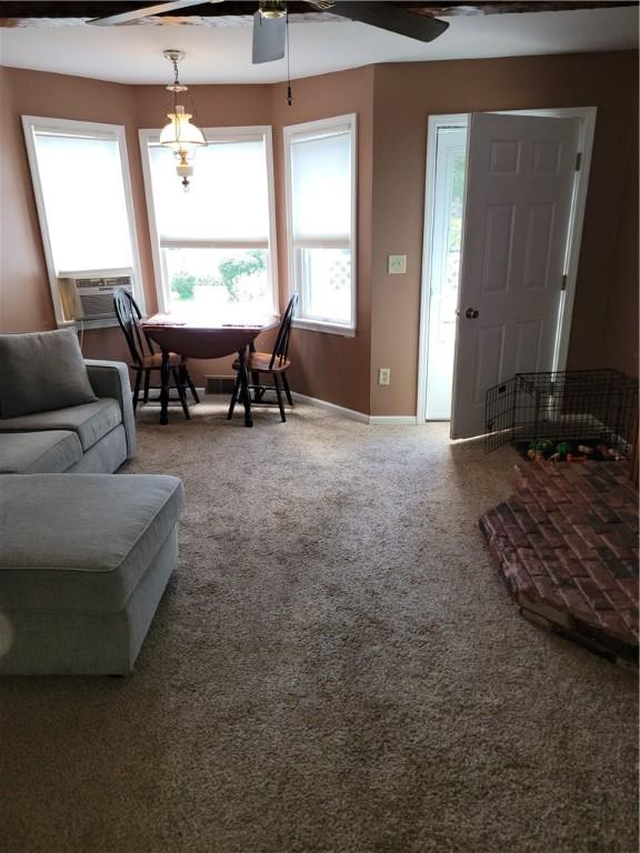 25 Francis Ave, Norwich, NY 13815 - living area with a ceiling fan, cooling unit, and carpet floors