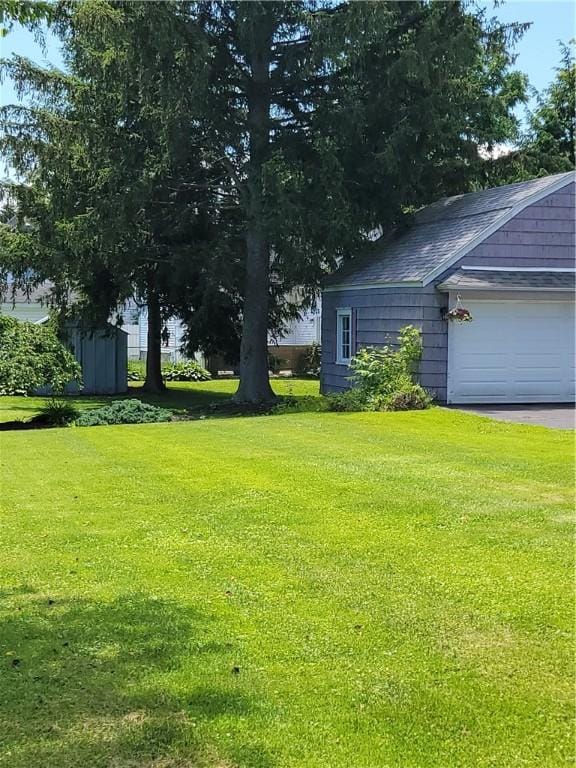 25 Francis Ave, Norwich, NY 13815 - view of green lawn with a garage