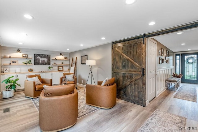 760 Westbrook Dr, North Tonawanda, NY 14120 - living room with a barn door, light wood-style flooring, and recessed lighting