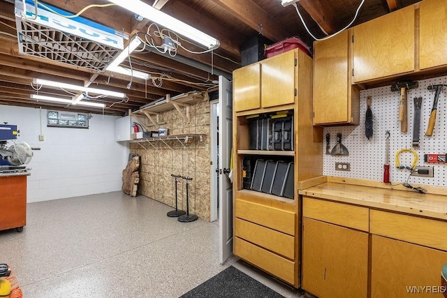760 Westbrook Dr, North Tonawanda, NY 14120 - below grade area featuring a workshop area and concrete block wall