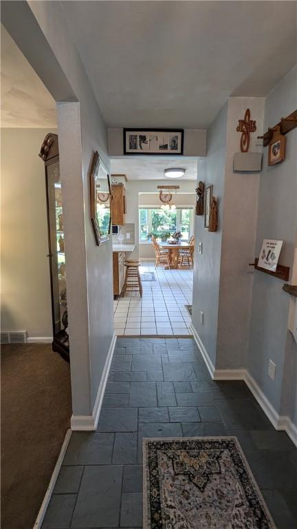 818 Tinker Tavern Rd, Webster, NY 14580 - corridor featuring baseboards and stone tile flooring