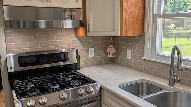 818 Tinker Tavern Rd, Webster, NY 14580 - kitchen with stainless steel range with gas cooktop, backsplash, and healthy amount of natural light