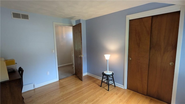 818 Tinker Tavern Rd, Webster, NY 14580 - unfurnished bedroom featuring light wood-style flooring and a closet