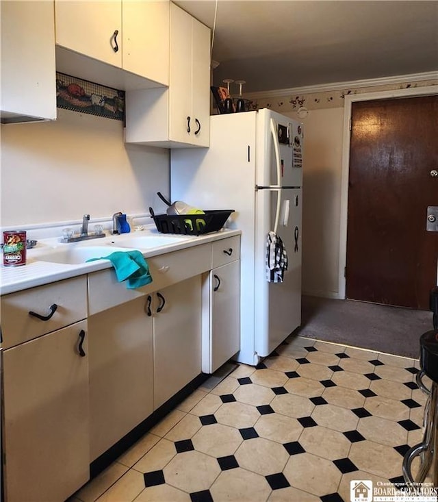 515 Newland Ave, Jamestown, NY 14701 - kitchen featuring light countertops, freestanding refrigerator, and white cabinetry