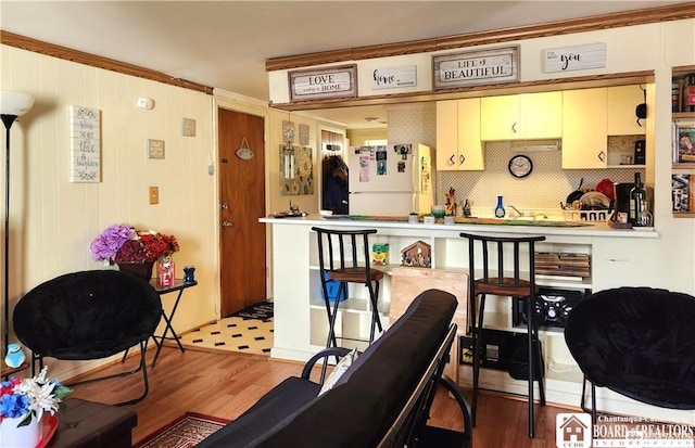 515 Newland Ave, Jamestown, NY 14701 - bar area with freestanding refrigerator, wood finished floors, and ornamental molding