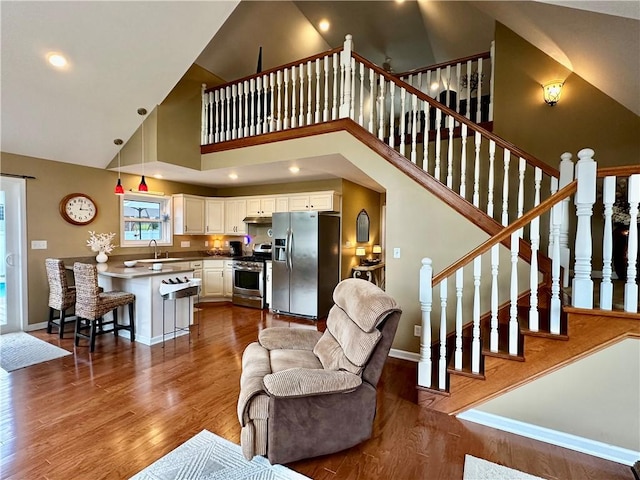 187 Seaward Ave, Bradford-City, PA 16701 - living room featuring high vaulted ceiling, dark wood-style floors, and stairway