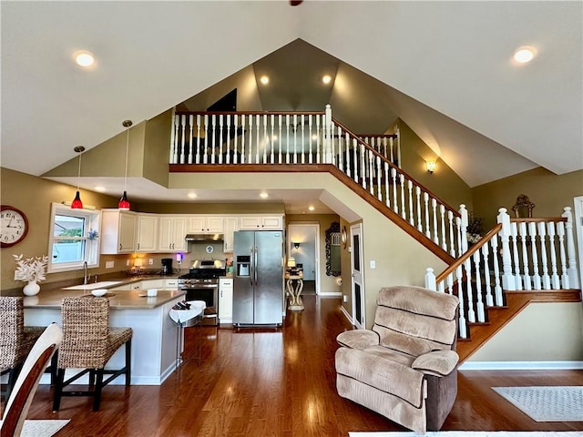 187 Seaward Ave, Bradford-City, PA 16701 - living area with high vaulted ceiling, dark wood-style floors, stairs, and recessed lighting