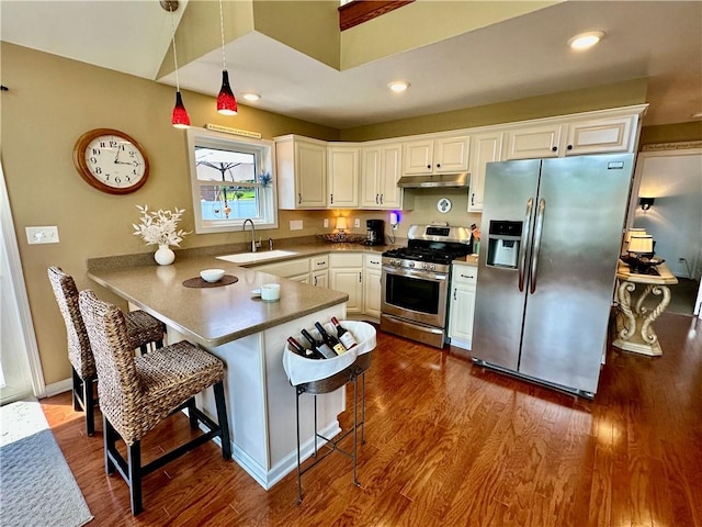 187 Seaward Ave, Bradford-City, PA 16701 - kitchen featuring stainless steel appliances, a peninsula, white cabinetry, dark wood finished floors, and a breakfast bar area