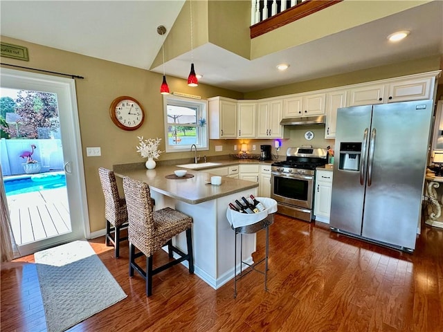 187 Seaward Ave, Bradford-City, PA 16701 - kitchen featuring stainless steel appliances, a peninsula, white cabinetry, dark wood-style flooring, and recessed lighting