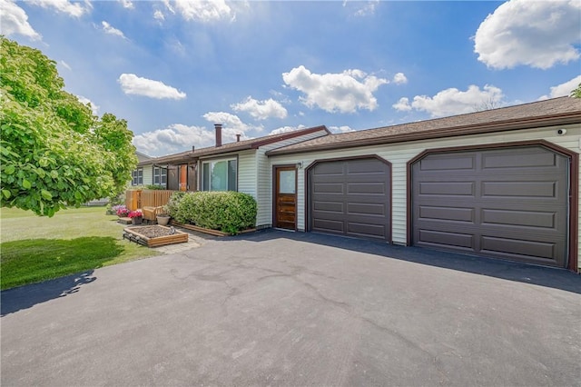 244 Wildflower Dr, Henrietta, NY 14623 - view of front facade with asphalt driveway, an attached garage, and a front yard
