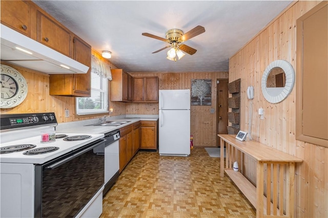 244 Wildflower Dr, Henrietta, NY 14623 - kitchen with white appliances, wooden walls, under cabinet range hood, ceiling fan, and light countertops