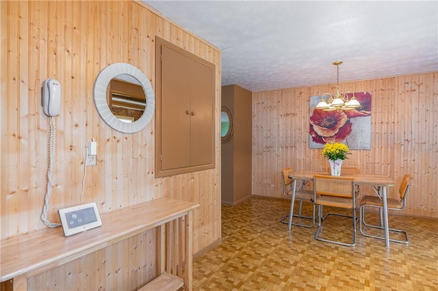 244 Wildflower Dr, Henrietta, NY 14623 - dining room featuring wood walls and a chandelier