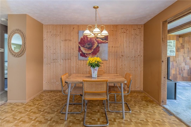 244 Wildflower Dr, Henrietta, NY 14623 - dining space featuring wooden walls and a chandelier