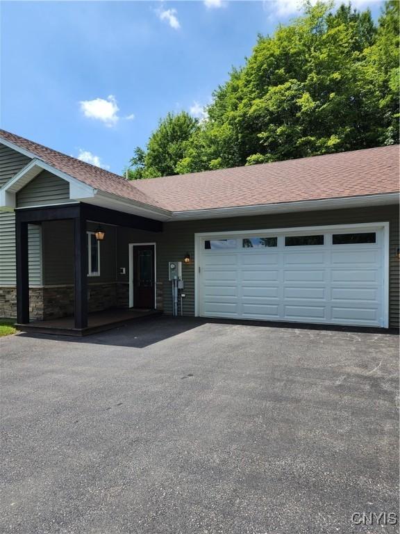 1683 Song Mountain Rd, Preble, NY 13141 - view of front of home featuring asphalt driveway, a garage, and roof with shingles