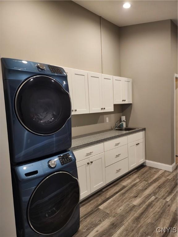 1683 Song Mountain Rd, Preble, NY 13141 - laundry area featuring stacked washing machine and dryer, dark wood-style flooring, cabinet space, and recessed lighting