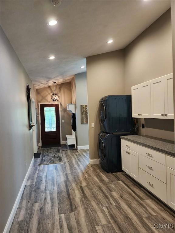 1683 Song Mountain Rd, Preble, NY 13141 - kitchen featuring stacked washing machine and dryer, dark wood finished floors, dark countertops, white cabinets, and recessed lighting