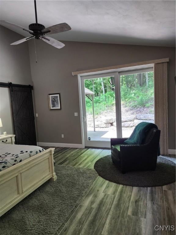 1683 Song Mountain Rd, Preble, NY 13141 - bedroom featuring vaulted ceiling, a barn door, access to outside, wood finished floors, and ceiling fan